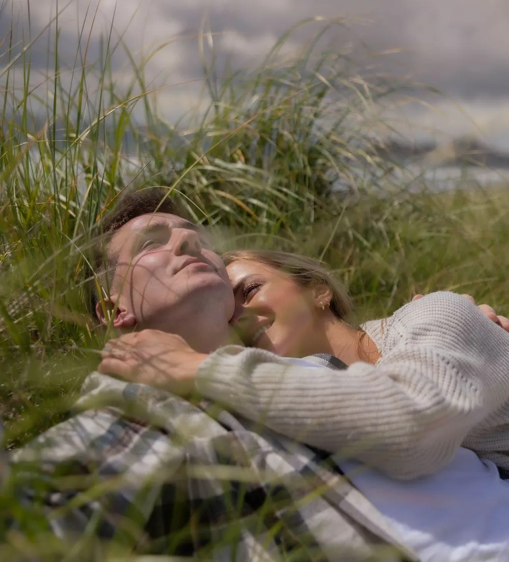 A couple resting in golden grass