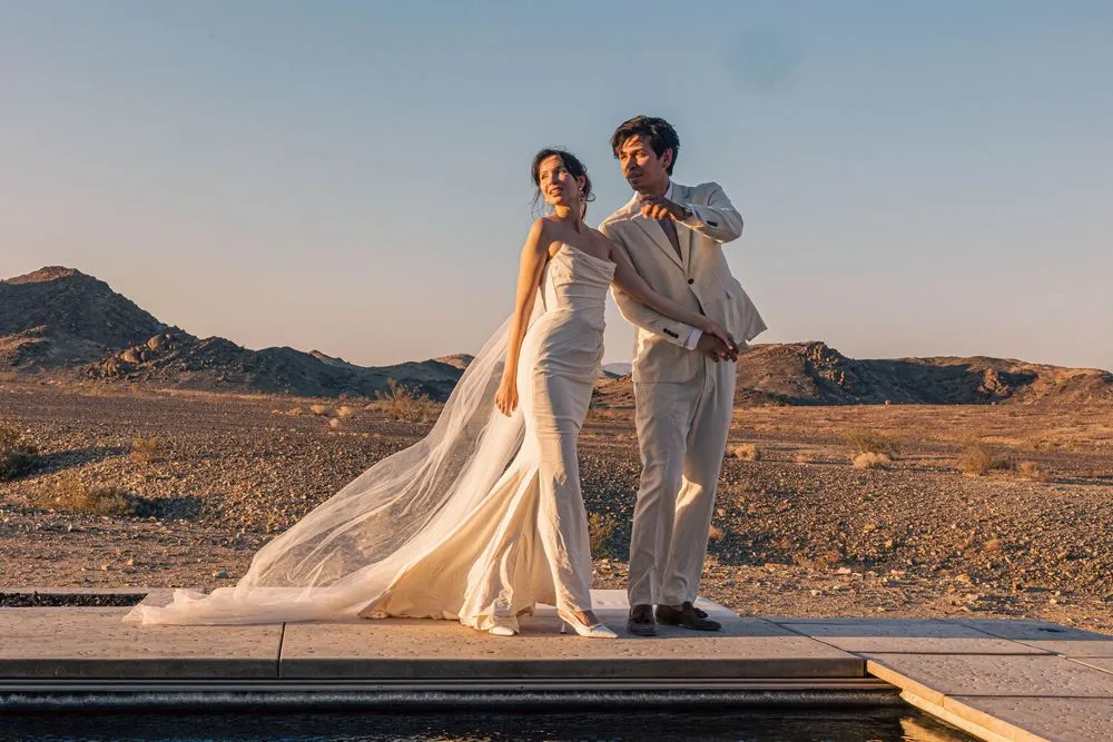 A couple on a cliff overlooking the ocean