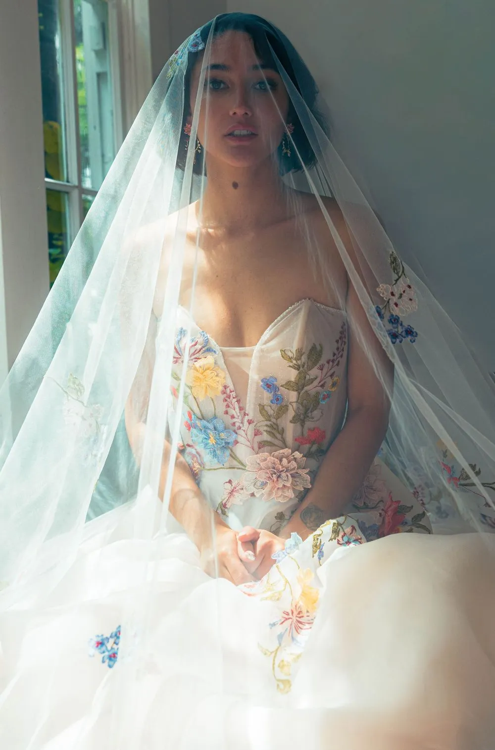 A bride in a floral gown and veil